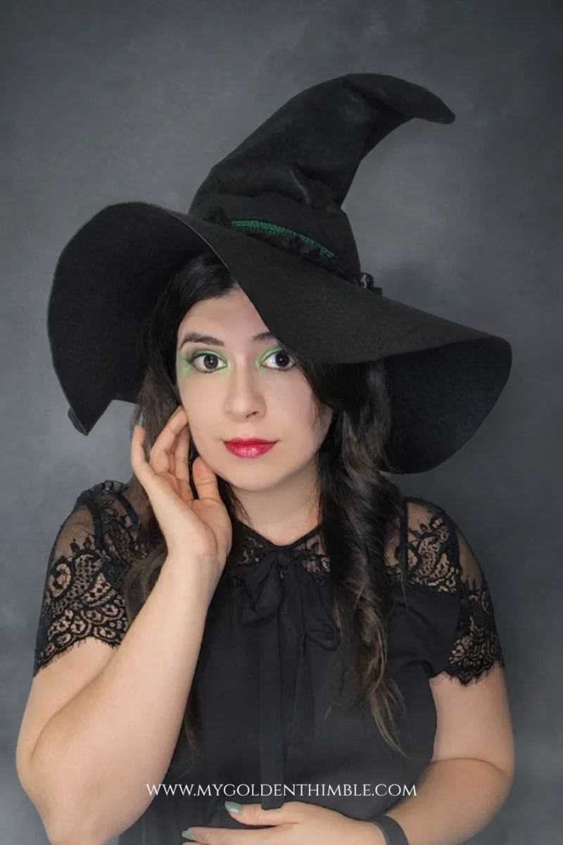 model wearing a black witch hat made with a free sewing pattern