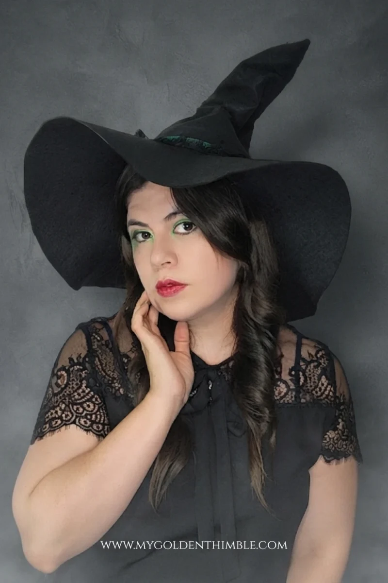 model wearing a black witch hat made with a free sewing pattern
