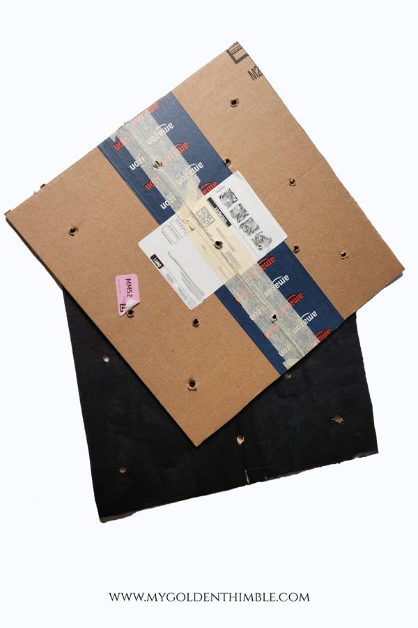 cardboard painted with holes