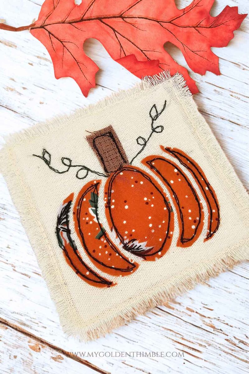 Sewing project idea for autumn: DIY fabric pumpkin coasters with appliqué leaves and vines.
