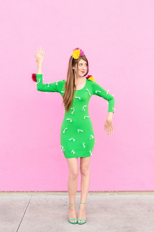 girl in a green dress with a pink background