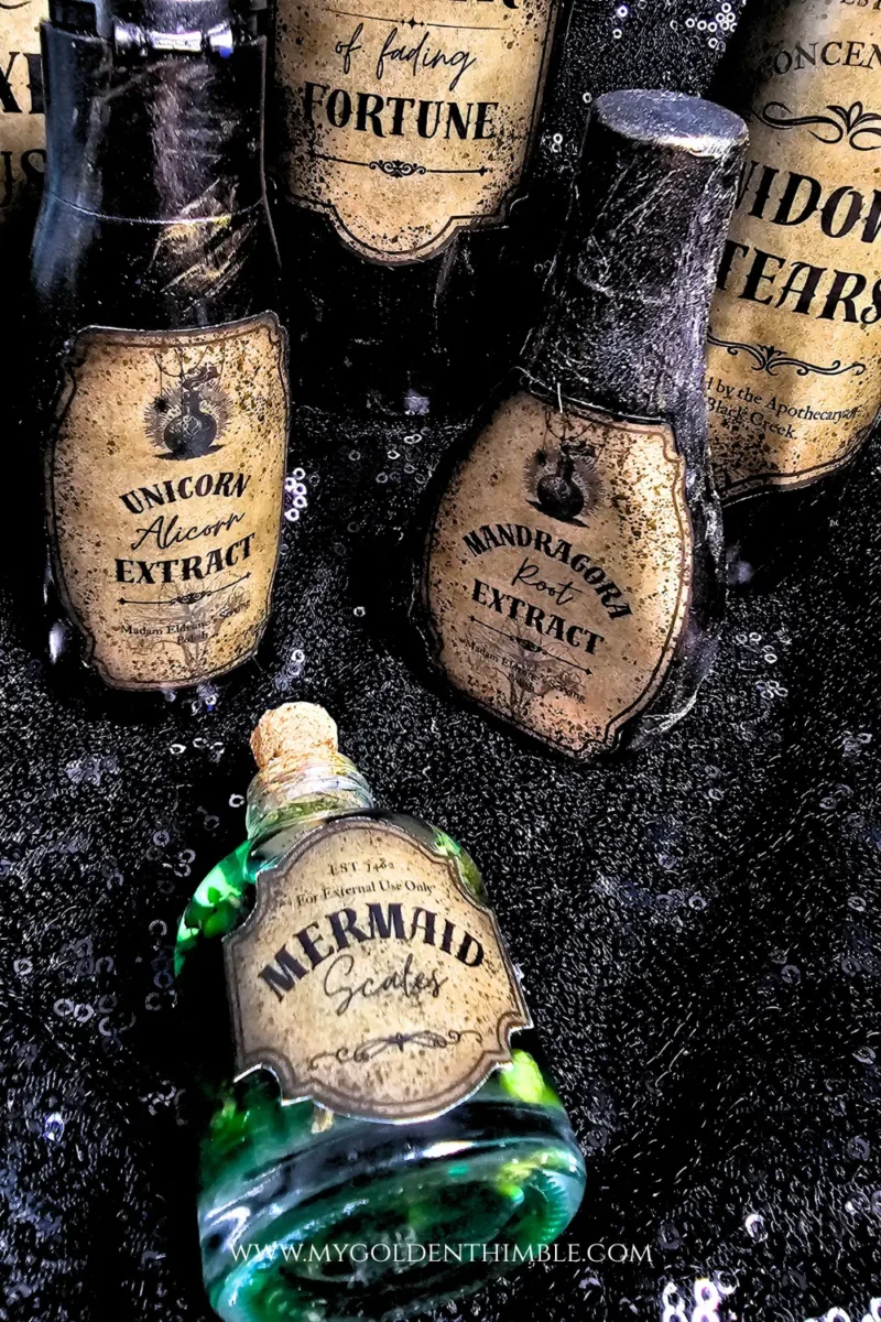 Set of DIY potion bottles from recycled bottles in various shapes and sizes, styled with free and premium printable labels for Halloween decoration.