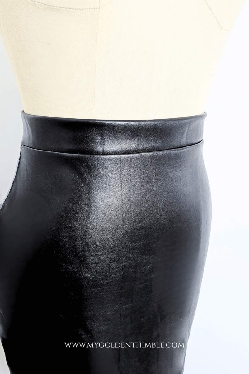 black leather skirt on a dress form close up