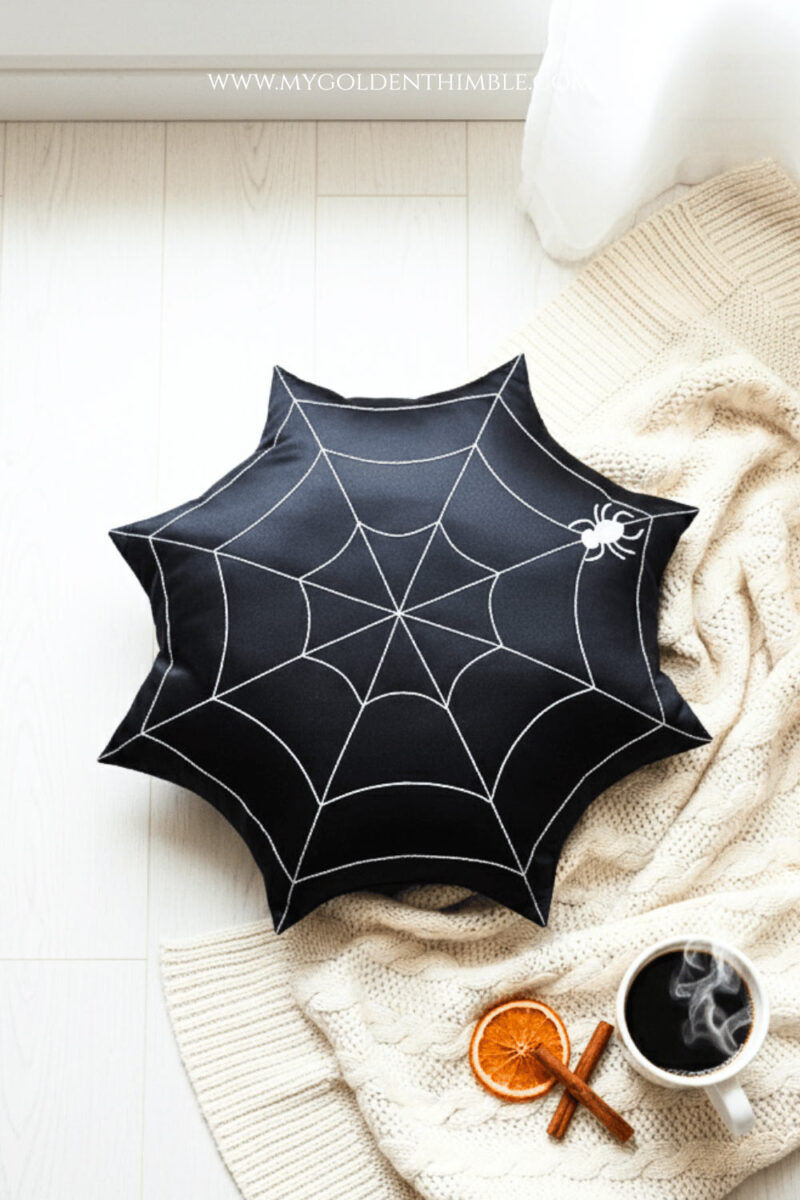 spider web pillows on a white couch