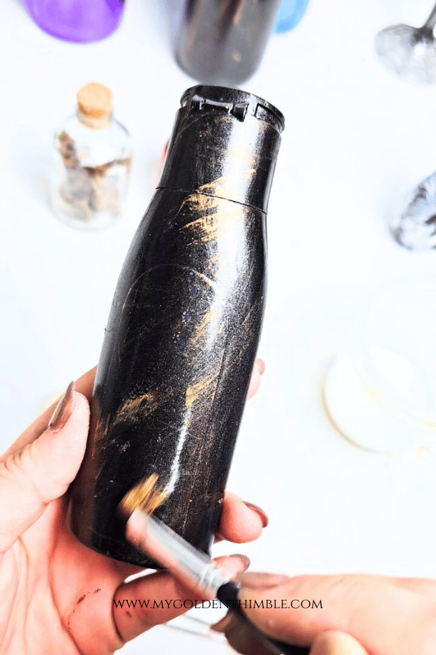 close up of dry brushing a bottle