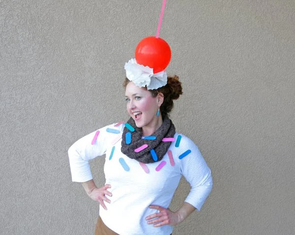 girl dressed as a sunday with a cherry on her head