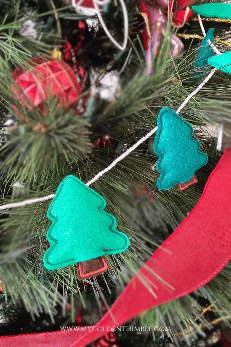 Finished tree felt garland hanging gracefully over a christmas tree
