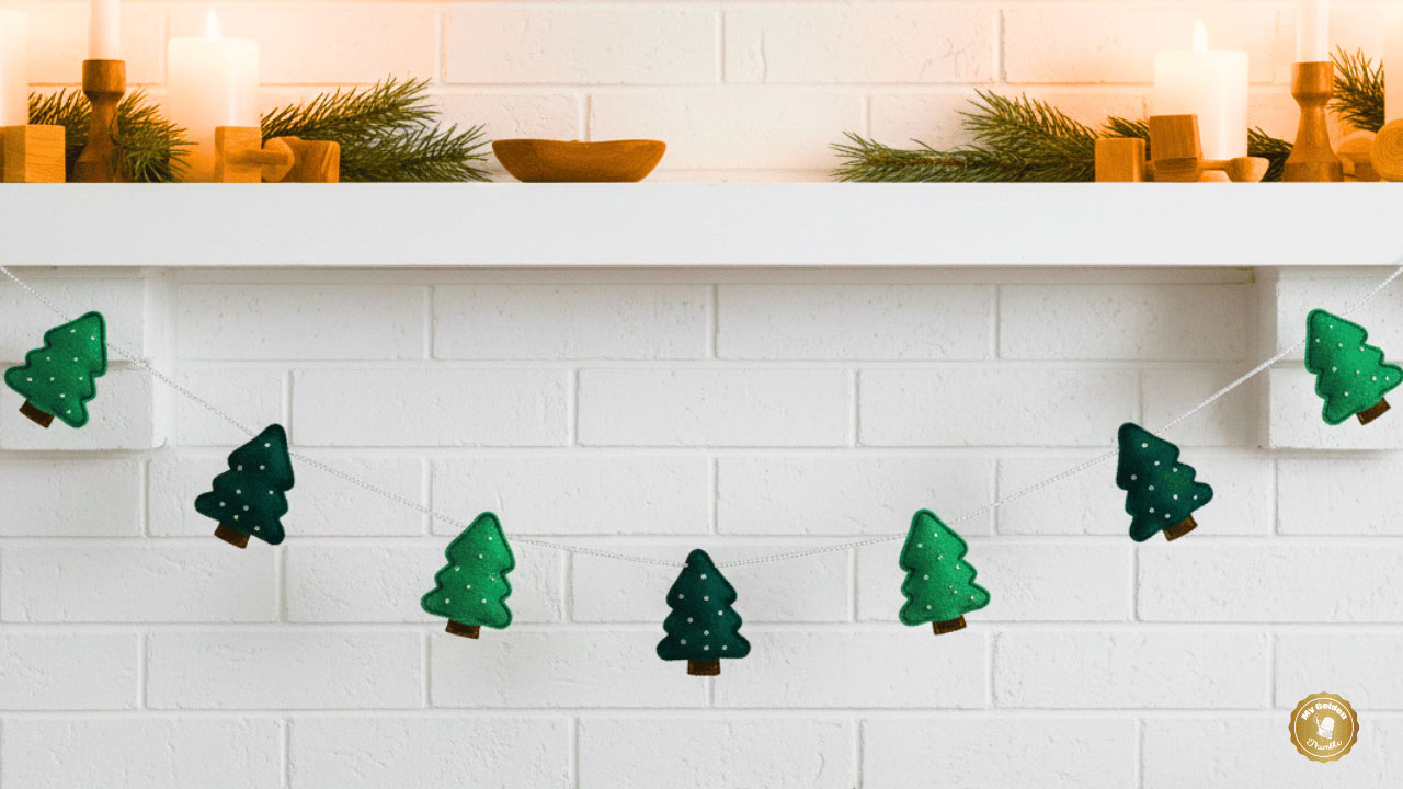 Finished Tree Felt Christmas Garland DIY hanging on a mantel with embroidered felt trees and beads.