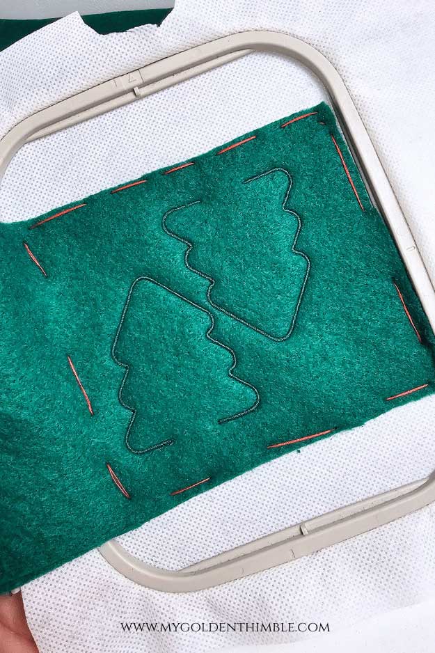 Embroidery machine stitching two felt trees for the Tree Felt Christmas Garland DIY.