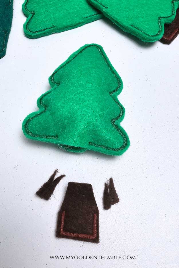 Felt trees being gently filled with stuffing before attaching trunks.