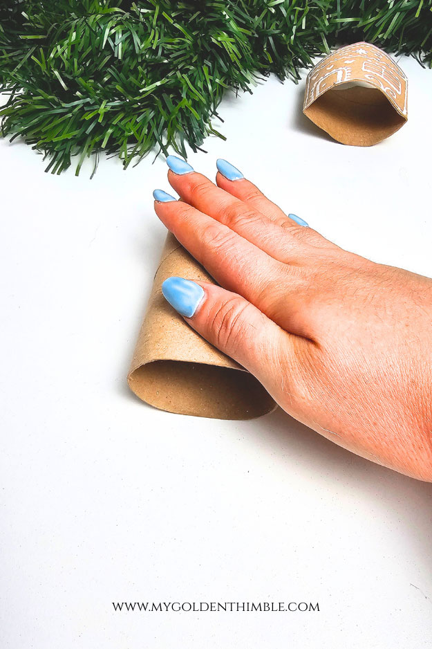 Flattened toilet paper rolls prepared for recycled cardboard Christmas crafts