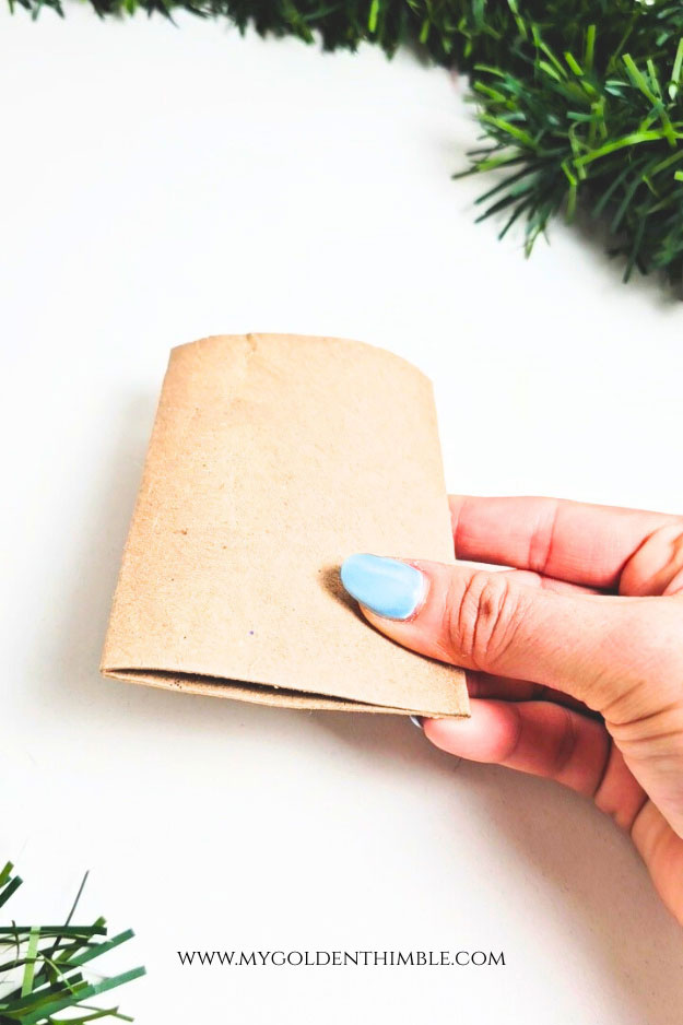 Flattened toilet paper rolls prepared for recycled cardboard Christmas crafts