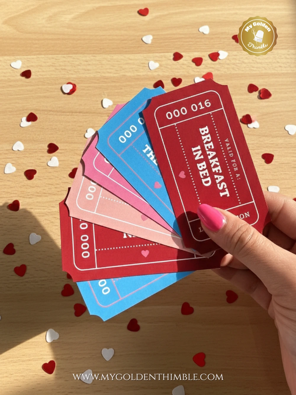 printable Valentine’s Day coupons in pink, red, and blue with romantic activities on a wooden surface.