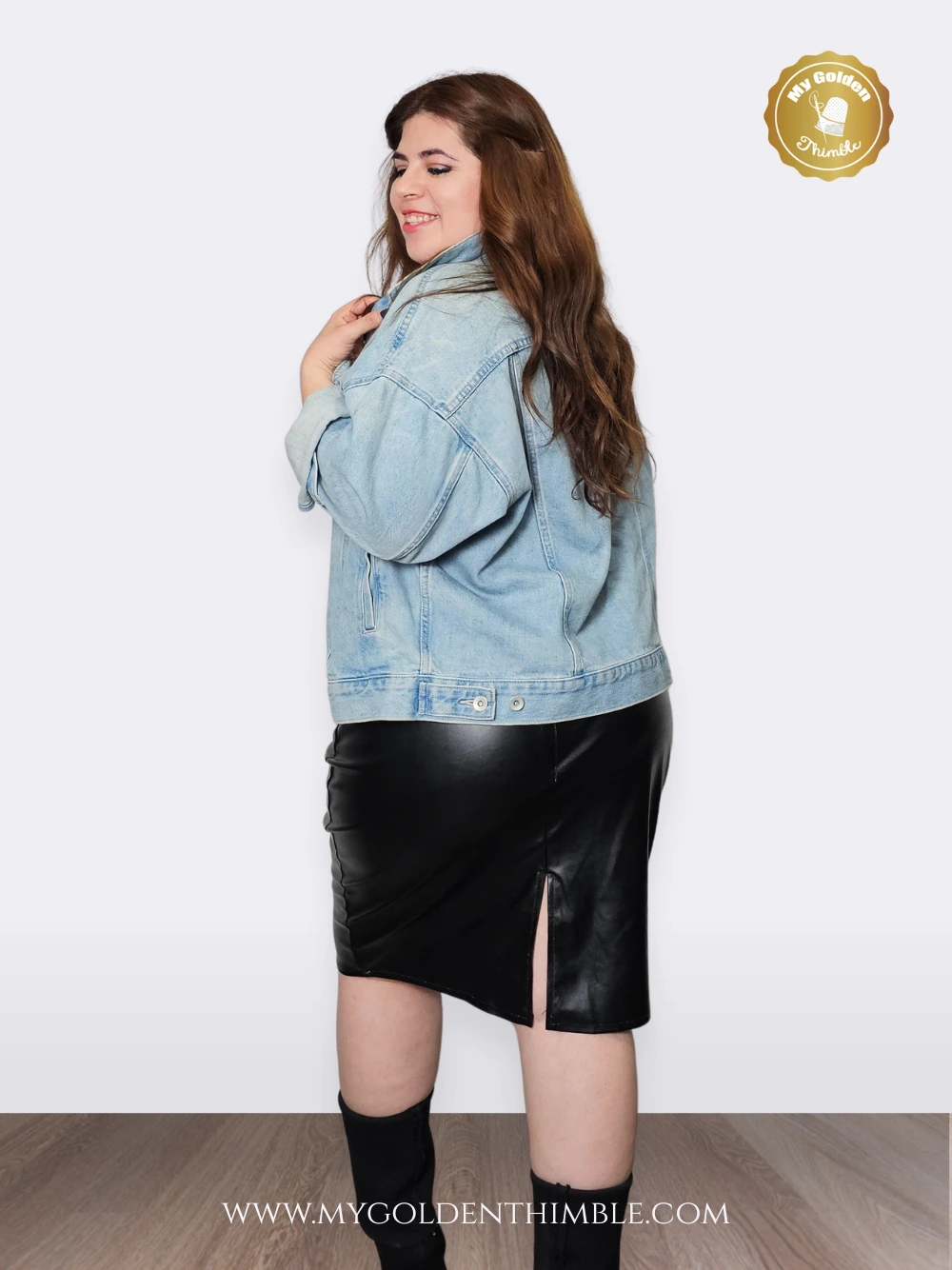 woman wearing a white top and a faux leather pencil skirt made with the violet stretch skirt pattern