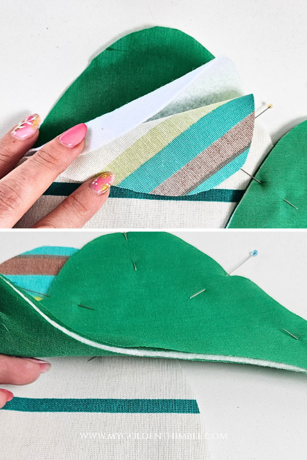 Layering cotton fabric and batting together to prepare the Easter egg potholder quilt sandwich