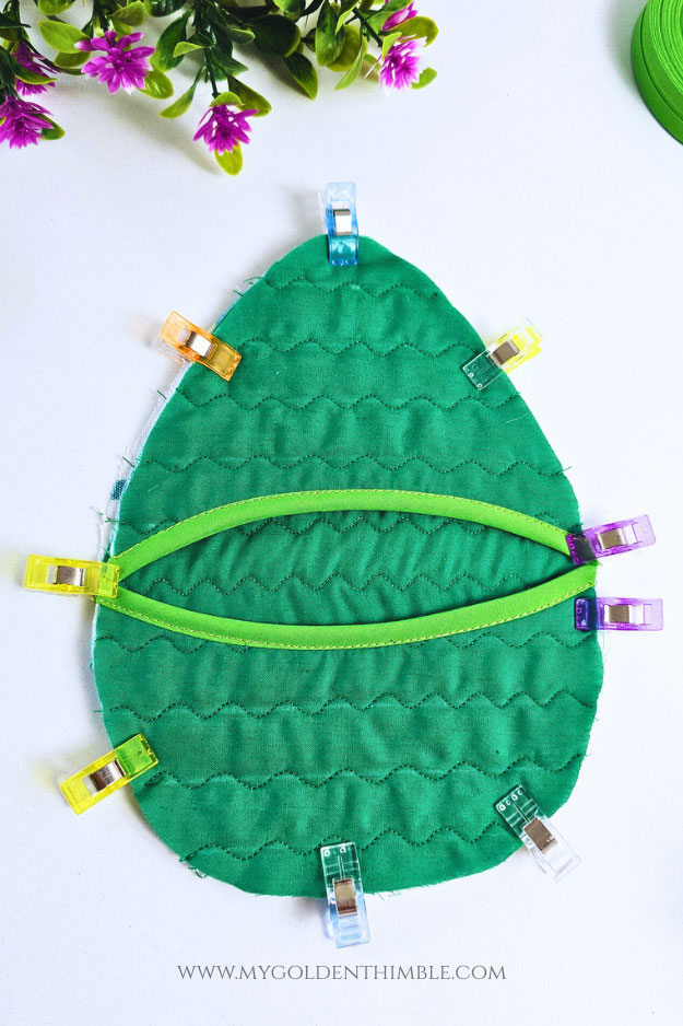 Layering the front pocket pieces on top of the backing fabric to assemble the egg potholder