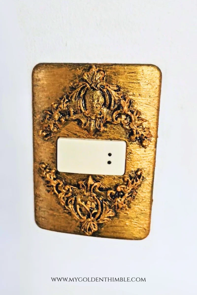 Vintage style light switch cover with aged copper look close-up