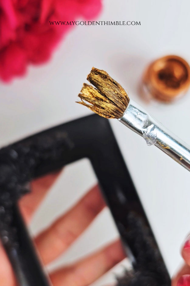 Dry brushing copper paint to create faux metal effect on plastic