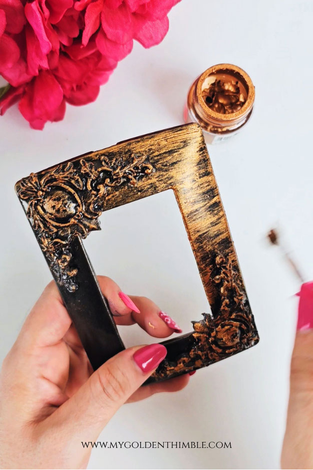 Dry brushing copper paint to create faux metal effect on plastic