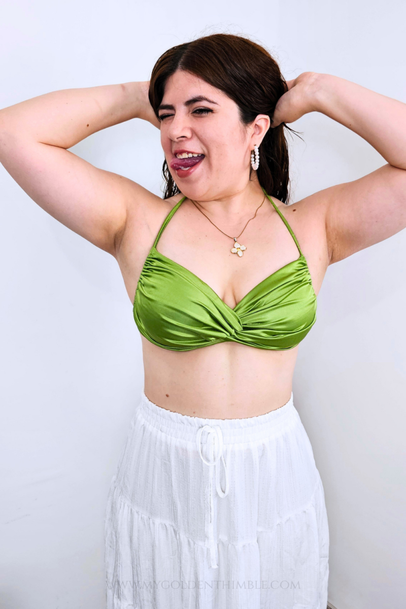 Model wearing the finished Buttercup Bikini Top with a twisted front and gathered details.