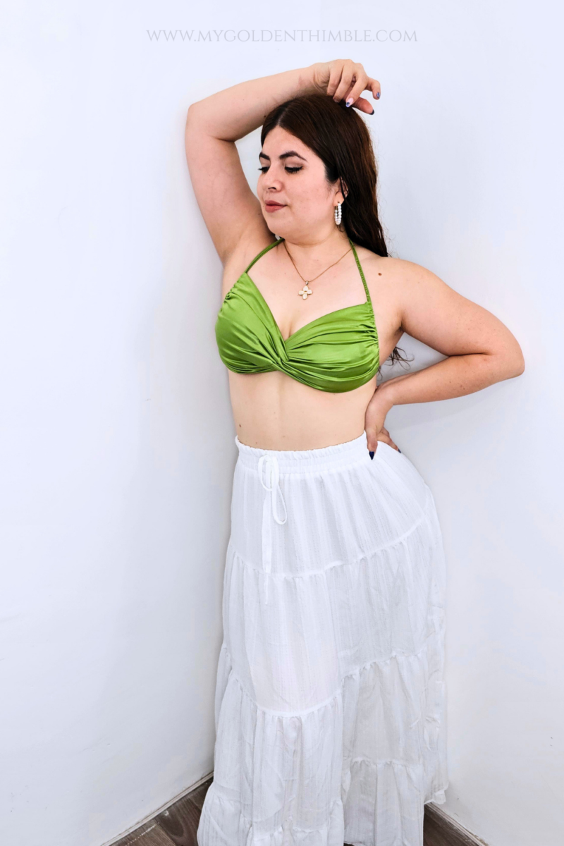 Model wearing the finished Buttercup Bikini Top with a twisted front and gathered details.