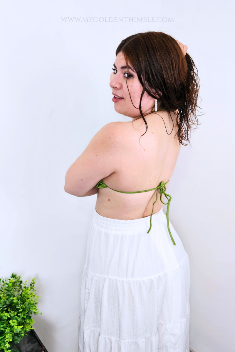 Model wearing the finished Buttercup Bikini Top with a twisted front and gathered details.