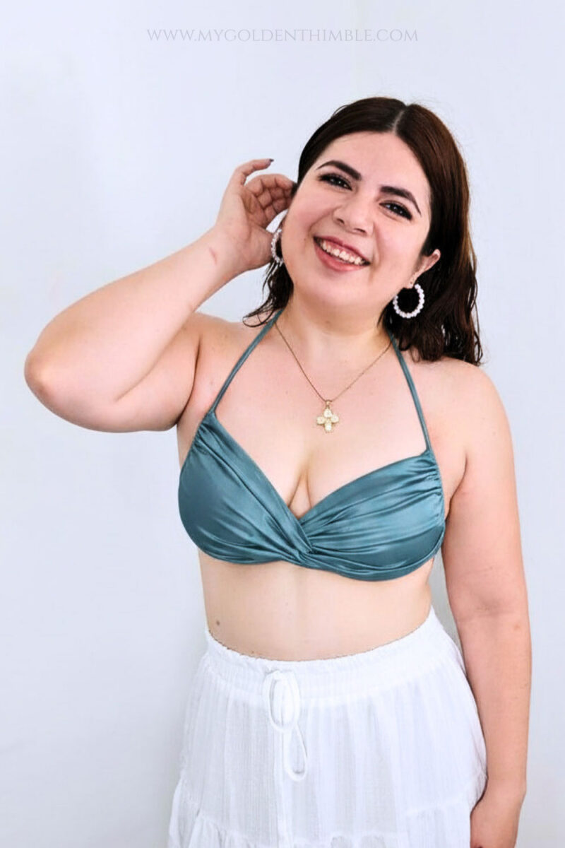 Finished free bikini top sewing pattern made with shiny blue swimwear fabric.