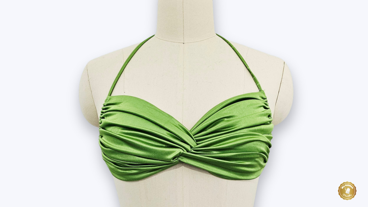 Finished Buttercup Gathered Bikini Top made from shimmer swim fabric with twisted front detail on a dress form