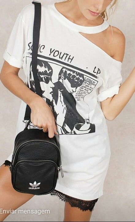 close uip of a woman wearing a white t-shirt thats cut on the shoulder
