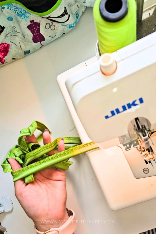 Sewing the long edge of the bikini strap with a serger.