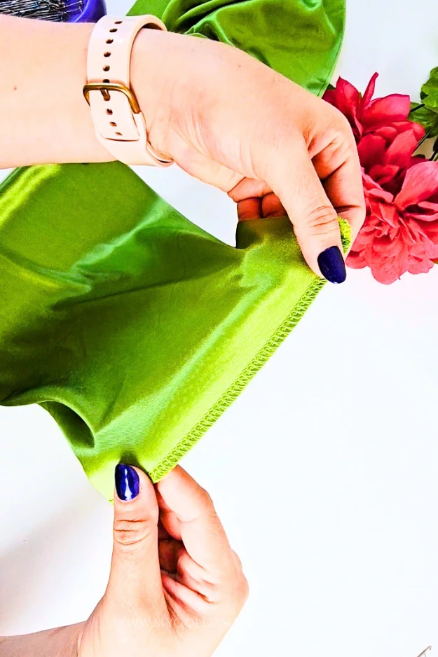 Serging the short edge of the folded rectangle to create the bikini cup.