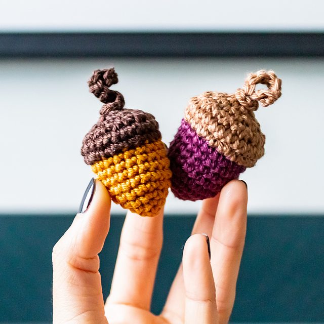 Crochet acorns in brown, orange, and purple with textured caps