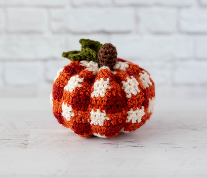 Crochet pumpkin decorated with a red and white checkered pattern