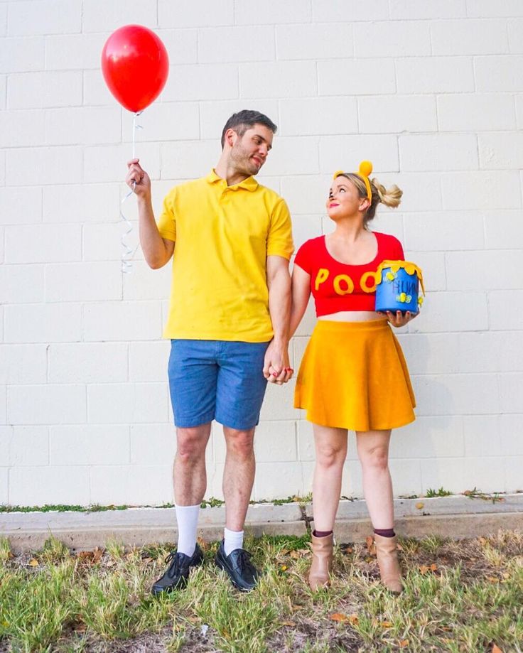 Two people dressed in costumes. The person on the left is wearing a yellow shirt, blue shorts, and holding a red balloon. Couples costume ideas, Diy couples costumes, Easy couples costumes