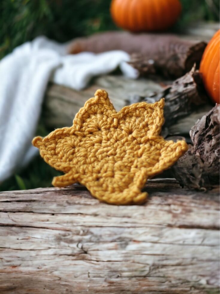 Crochet maple leaf in mustard yellow with detailed stitched veins