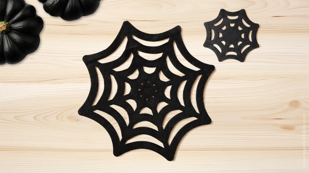 Black felt spider web placemat on a decorated table