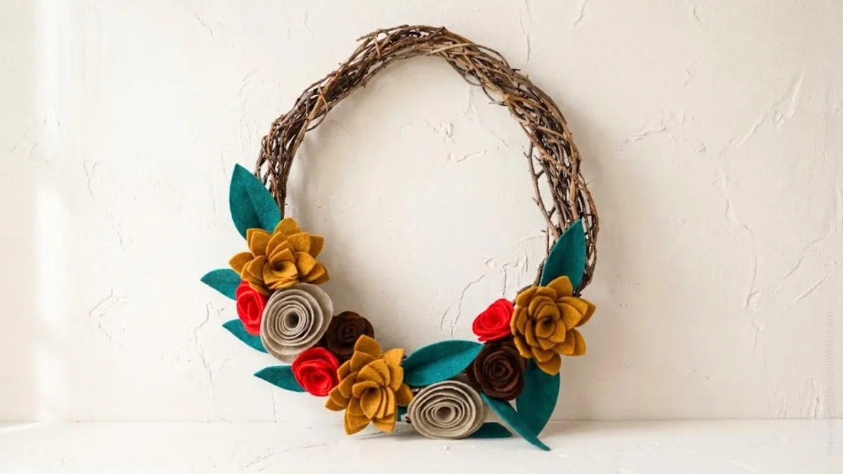 Finished felt flower wreath made with colorful rolled felt flowers and leaves