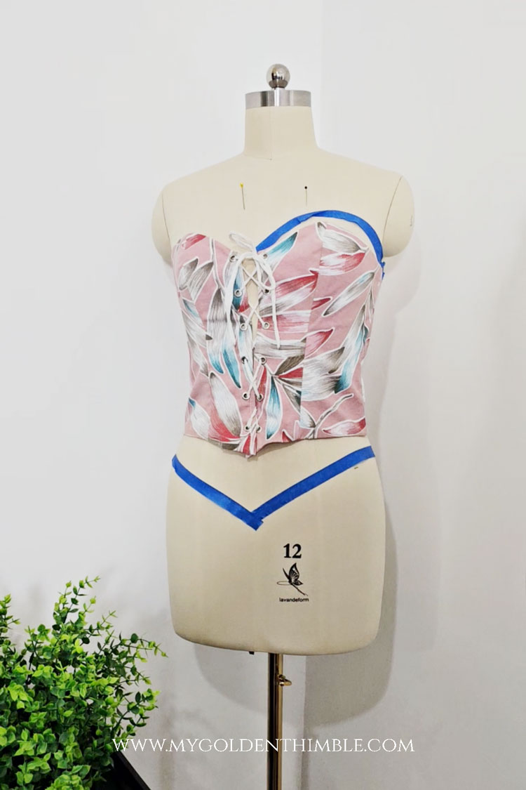 Custom-pink Rose Corset Pattern mounted on a dress form during the construction phase.
