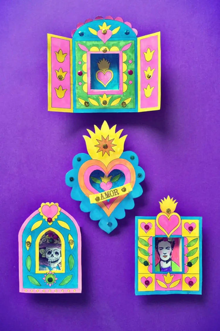Colorful handmade paper shrines and nichos with shrine doors on a purple background.