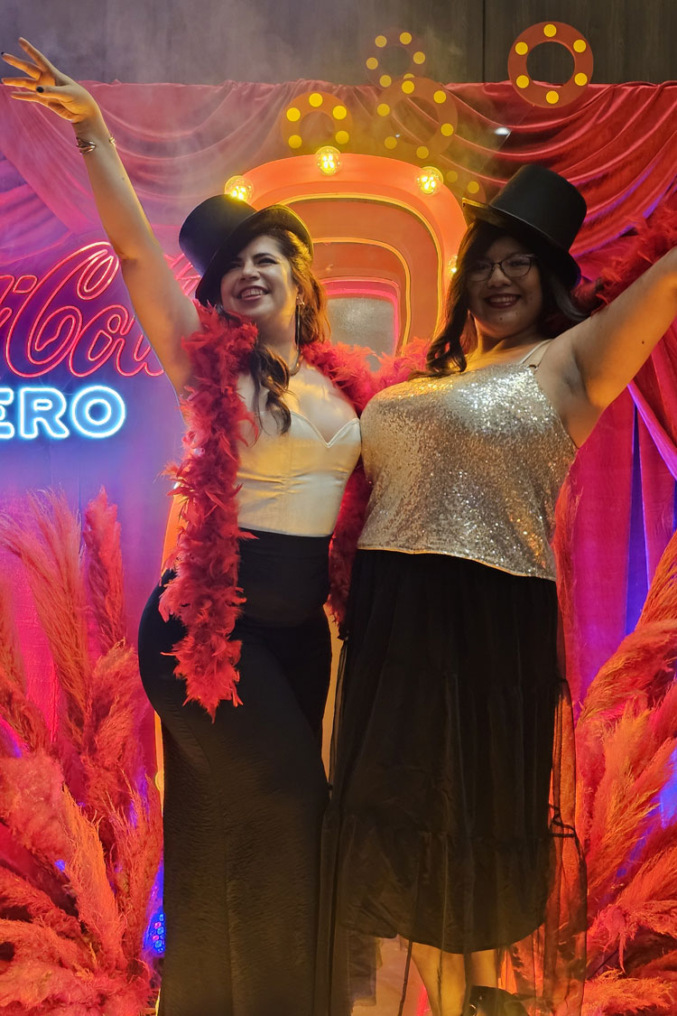 Two woman with burlesque accesories